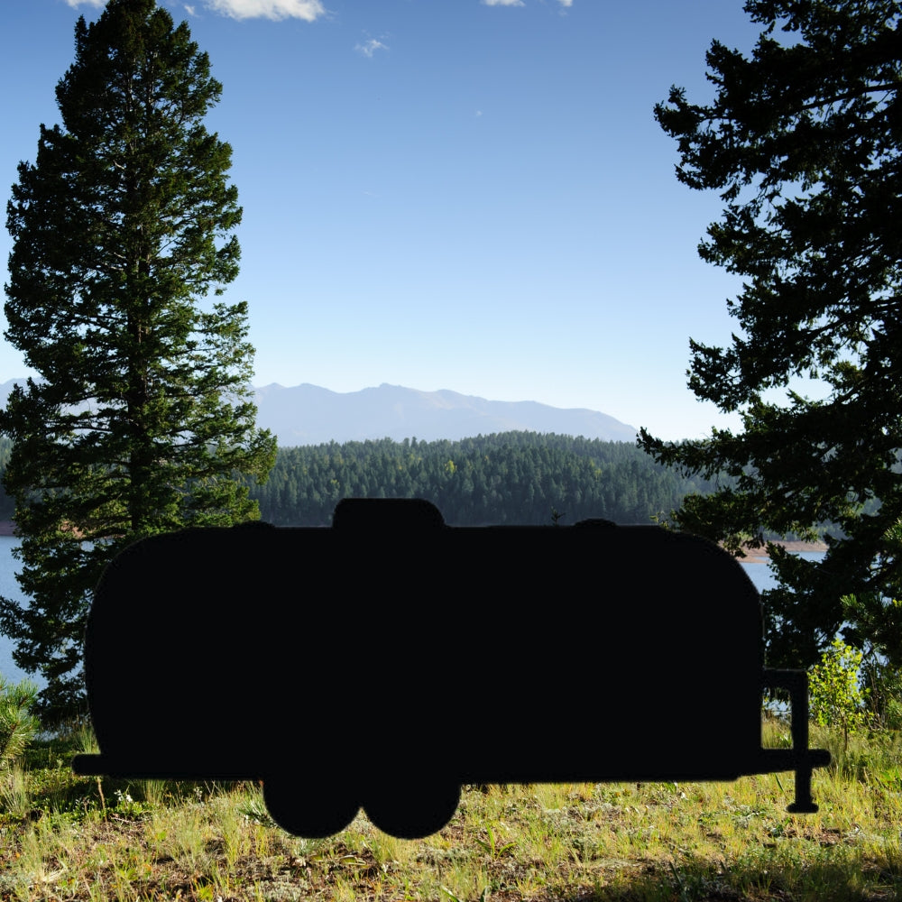 Precut glass shape of AirStream Trailer near lake.