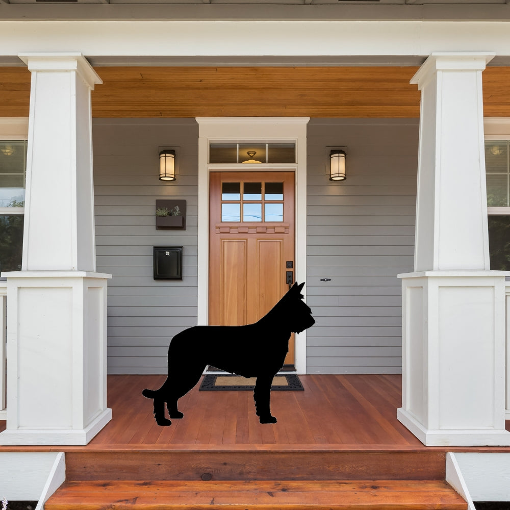 Precut glass shape of a berger picard dog on a front porch.