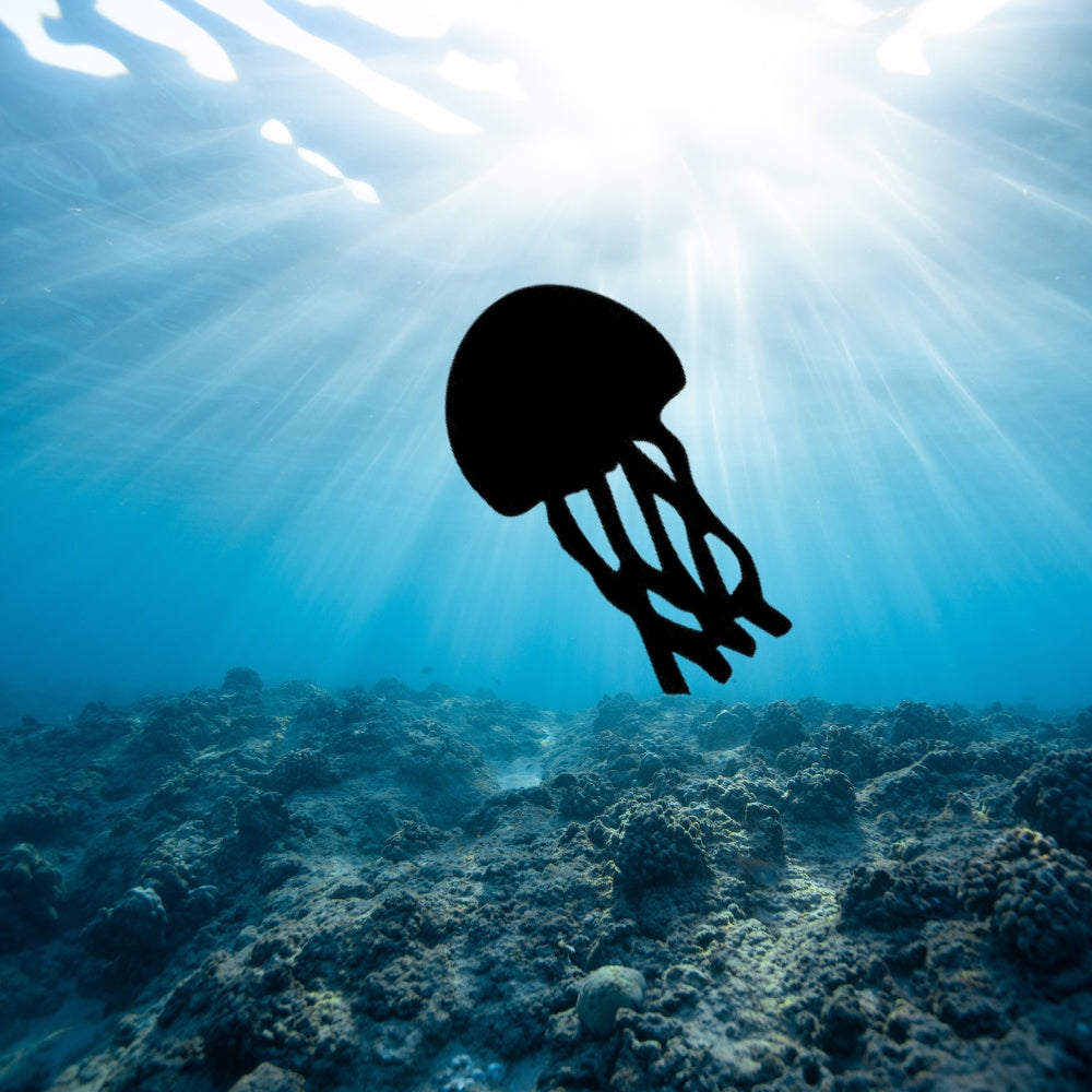 Precut glass shape of jellyfish in ocean.
