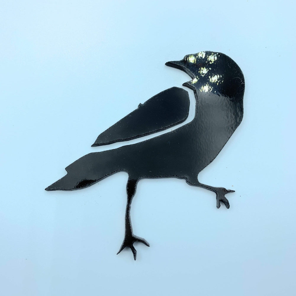 Precut glass shape of a raven.