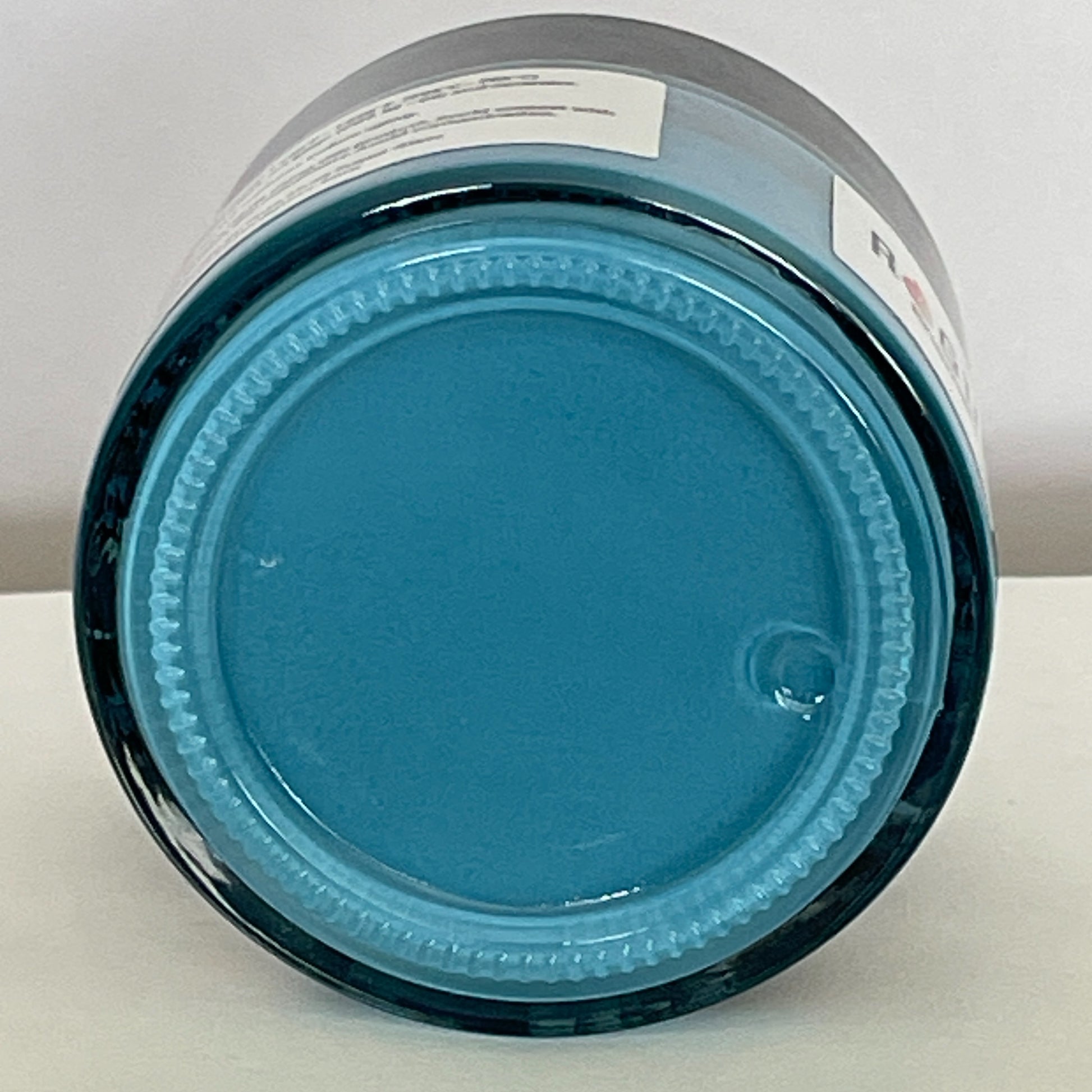 Jar of Triaxial Turquoise screen printing paste shown from the base, highlighting its vibrant tropical blue color and smooth, creamy texture