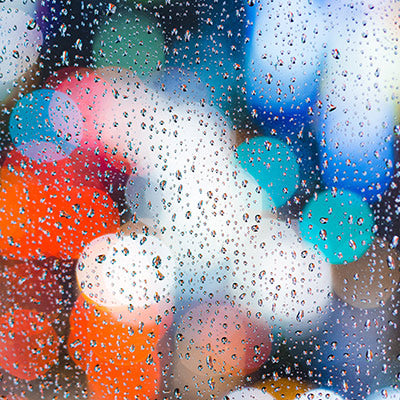 Close up image of multicolored fused glass with raindrops, for decoration only