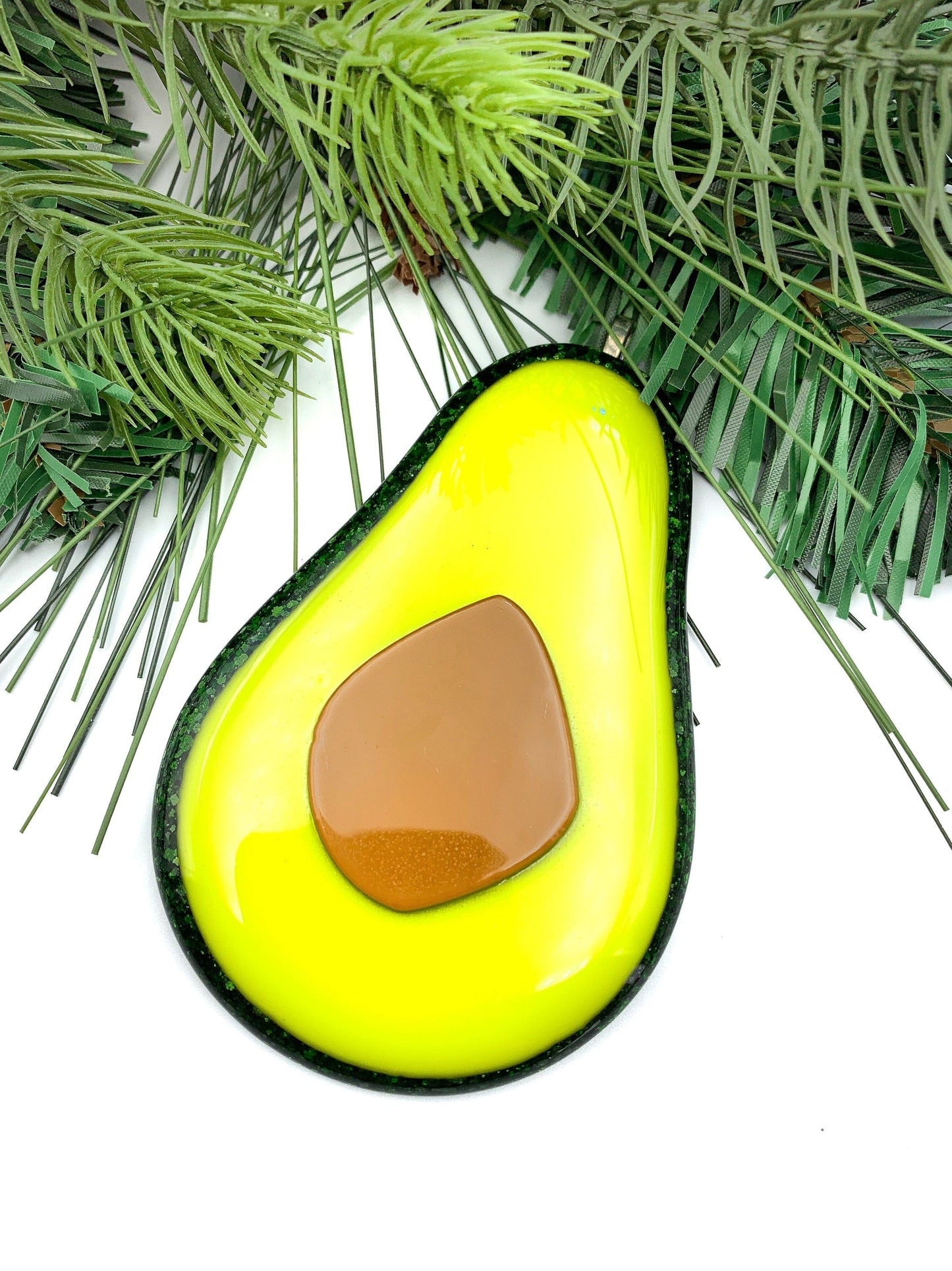 Avocado Christmas ornament against a festive background