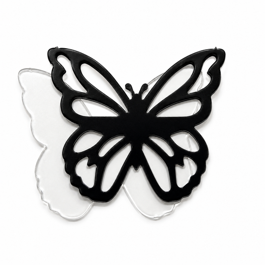 Black butterfly outline layered over a clear precut glass butterfly for a fused glass art project.