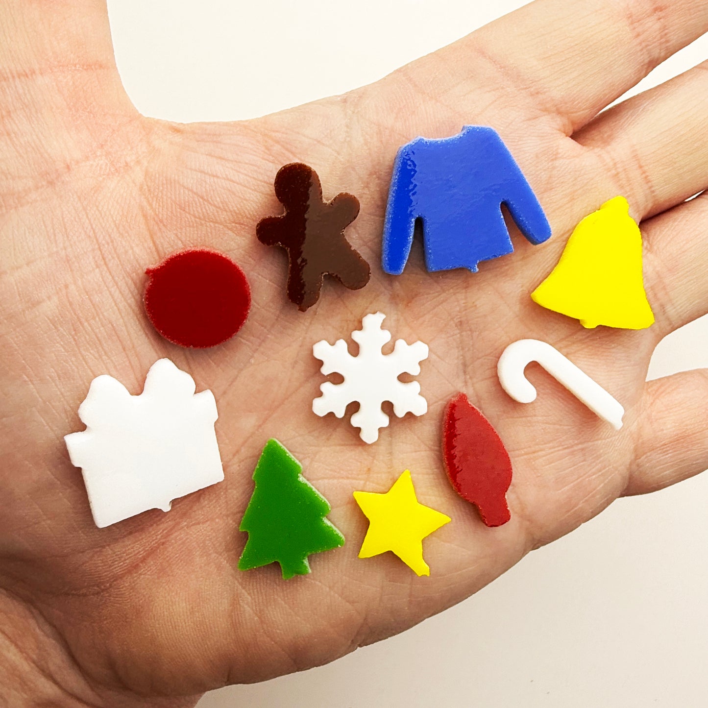 Christmas Mini Precuts set in COE 96 glass featuring 10 tiny holiday shapes—bells, stars, trees, snowflakes, candy canes, baubles, and more.