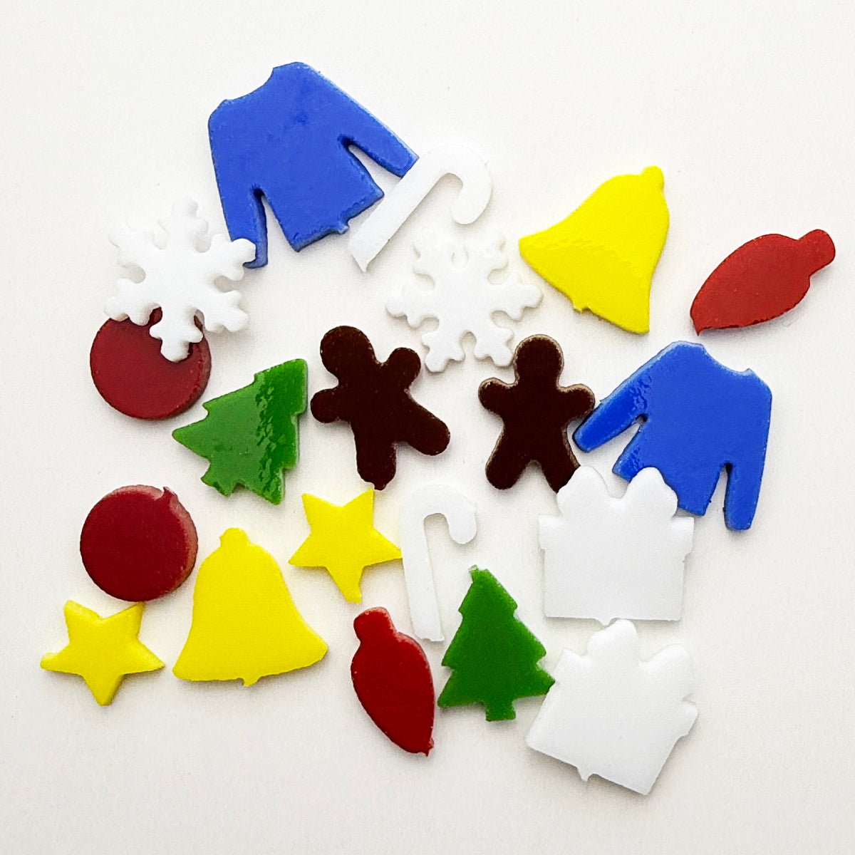 20-piece variety pack of tiny COE 96 Christmas glass precuts packaged by Fuse Muse Fused Glass, ideal for ornament embellishment and fused glass art.