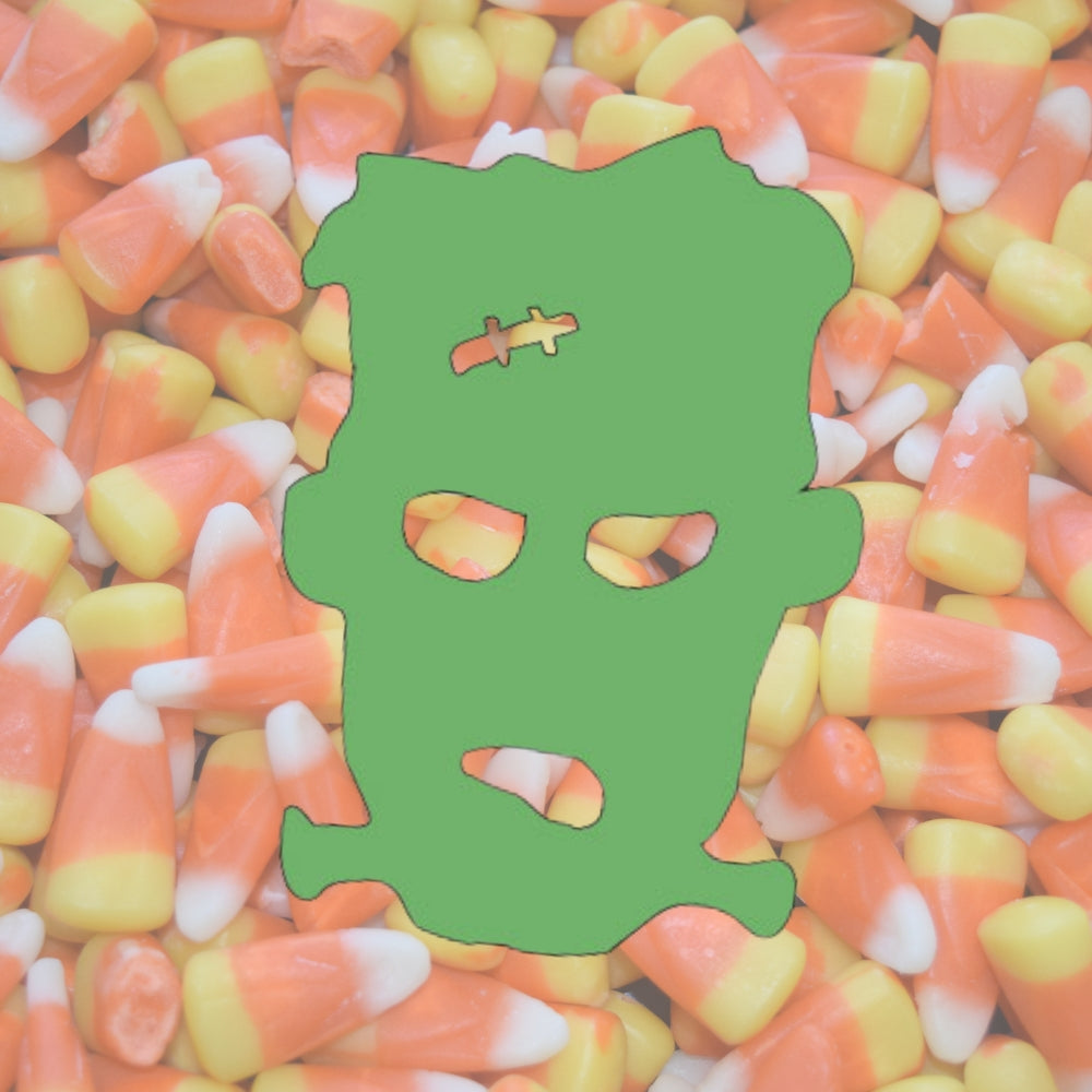 Green Frankenstein head precut on a background of Halloween candy