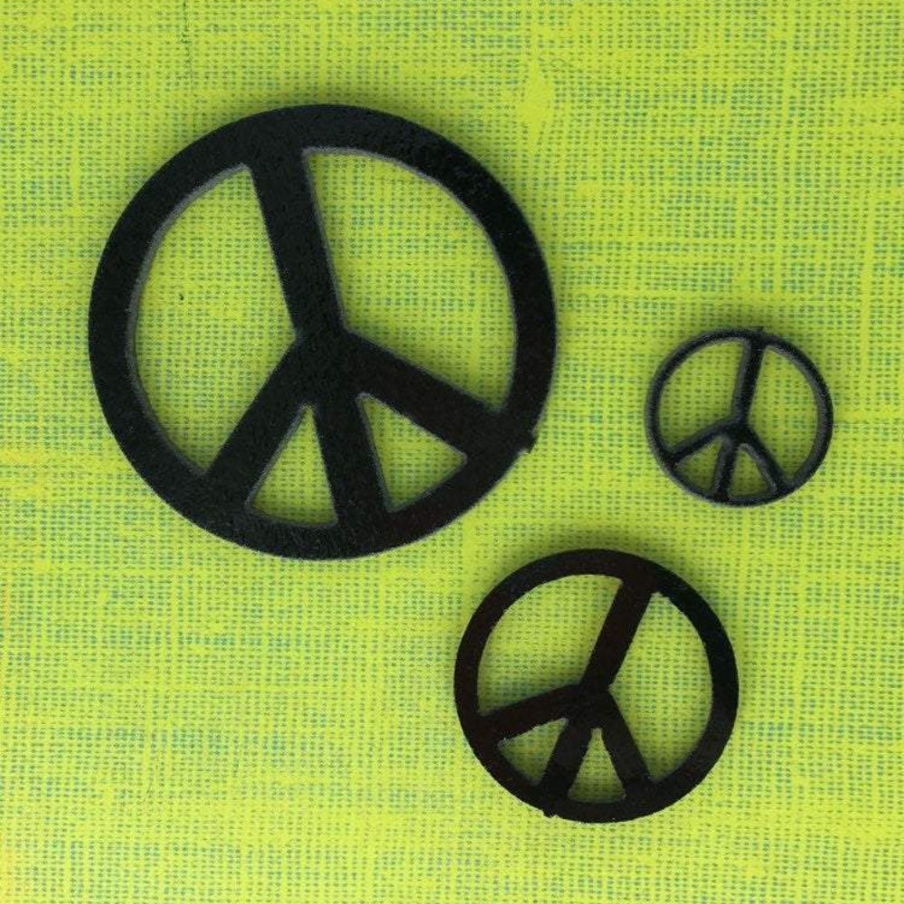 Precut glass shape of a peace sign in black glass.