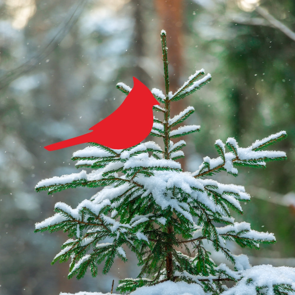 Precut glass shape of cardinal in a tree.