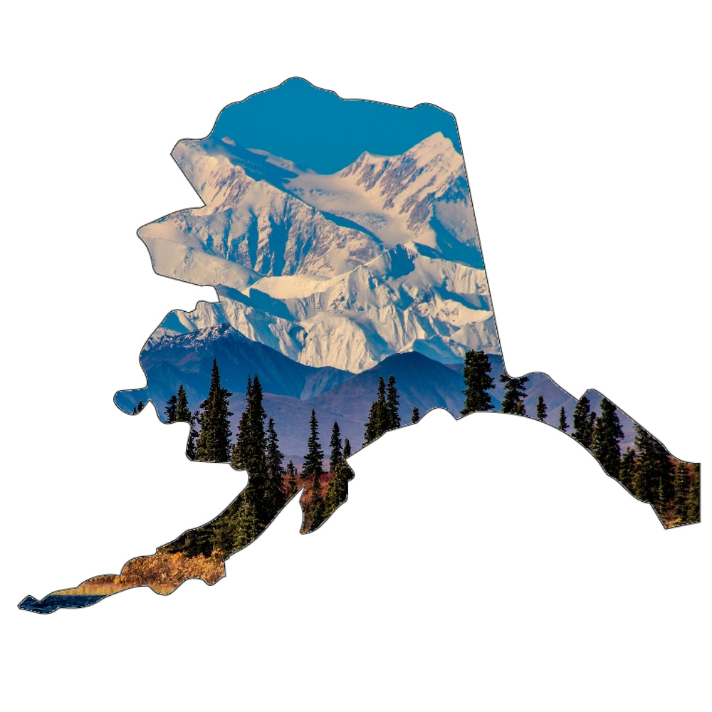 Precut glass shape of Alaska with a landscape within the outline.
