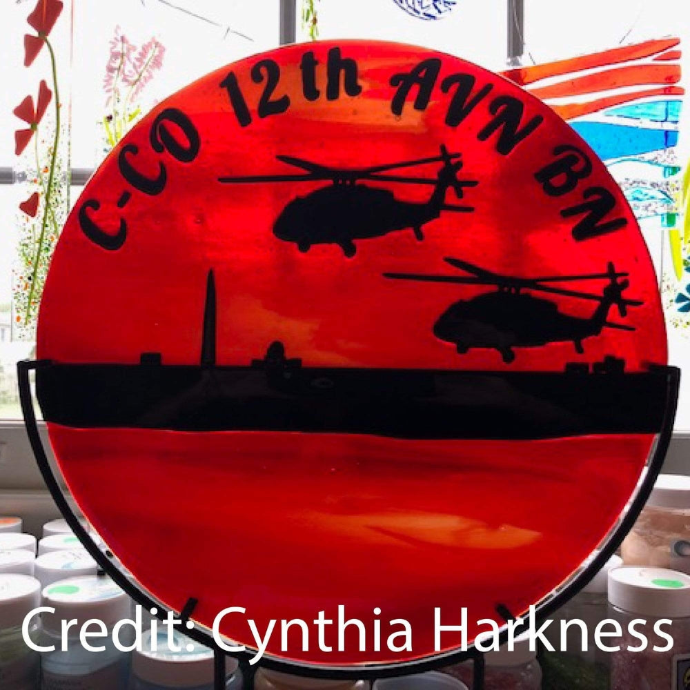 Precut glass shape of a blackhawk helicopter in an art piece by Cynthia Harkness.