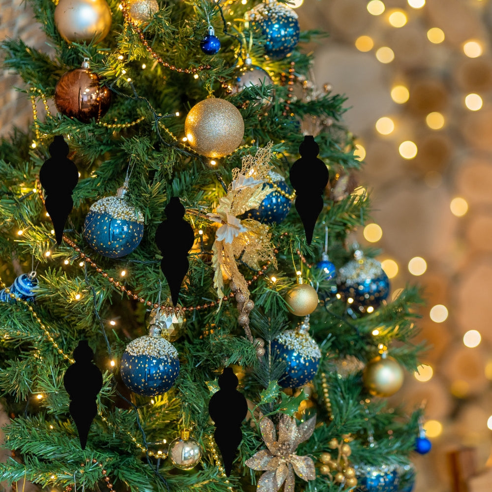 Precut glass shape of Christmas ornaments on tree.