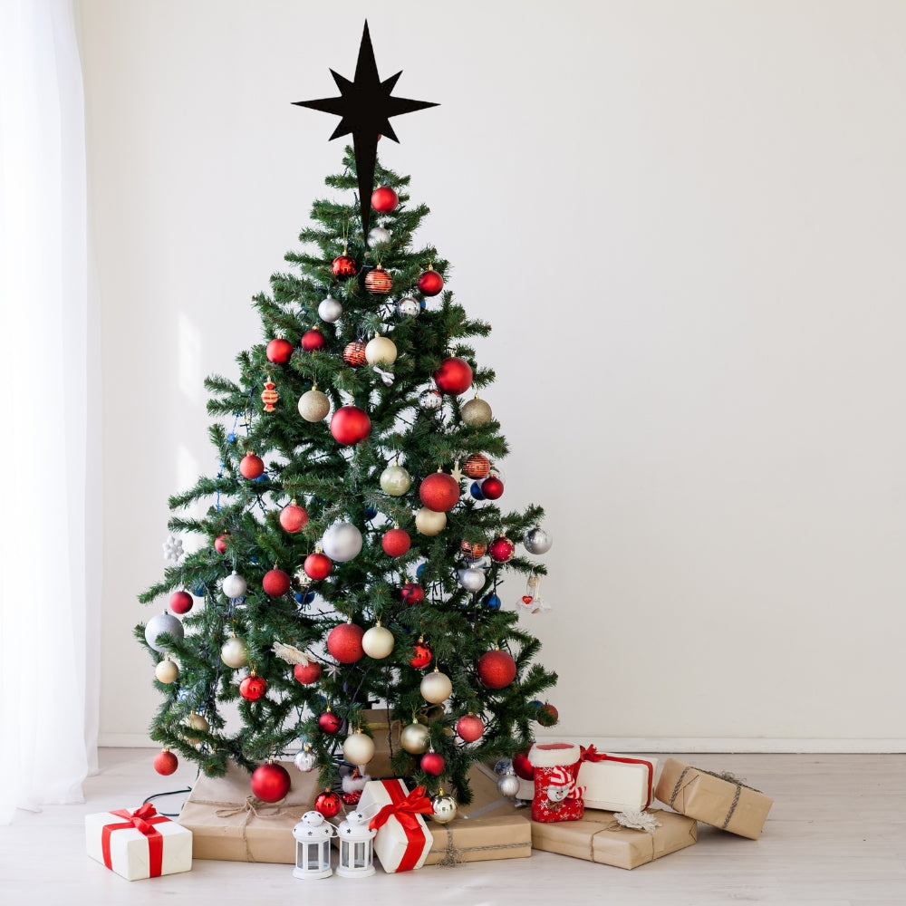 Precut glass shape of Christmas star on tree.