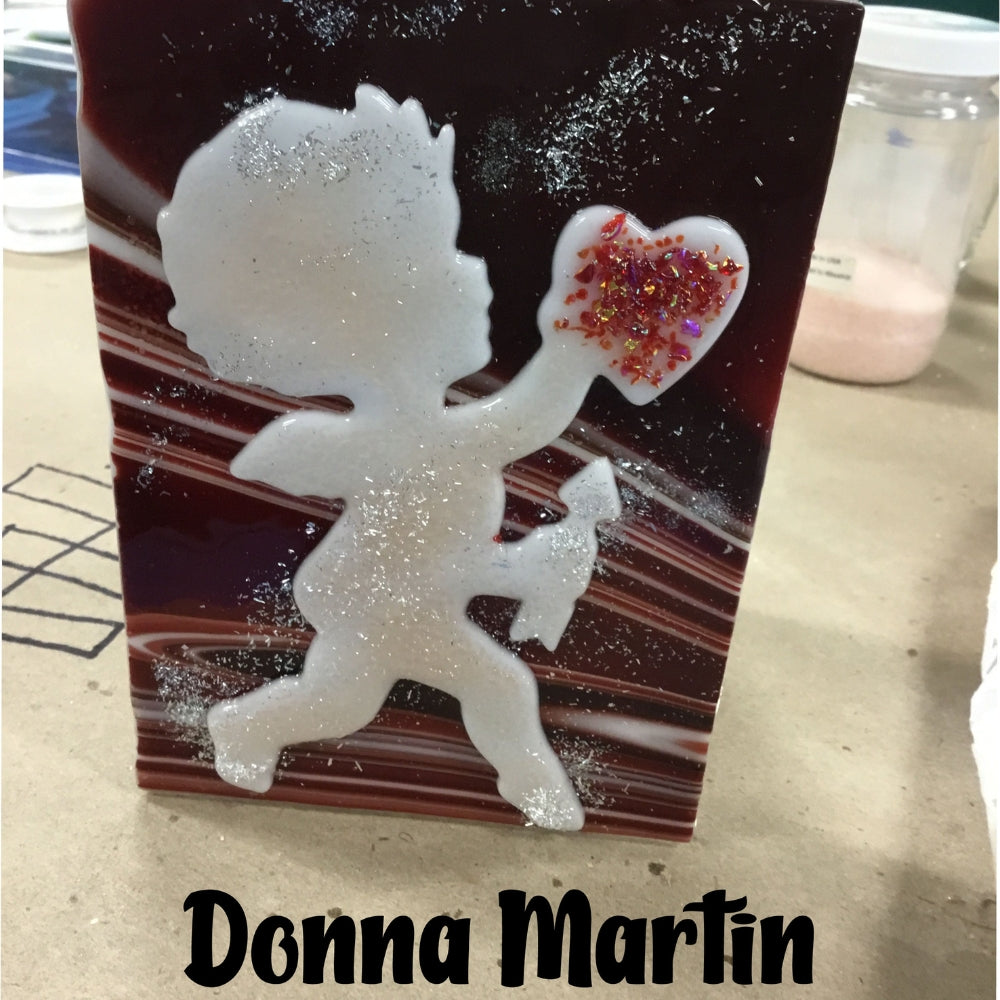 Precut glass shape of a cupid with heart in an art piece by Donna Martin.