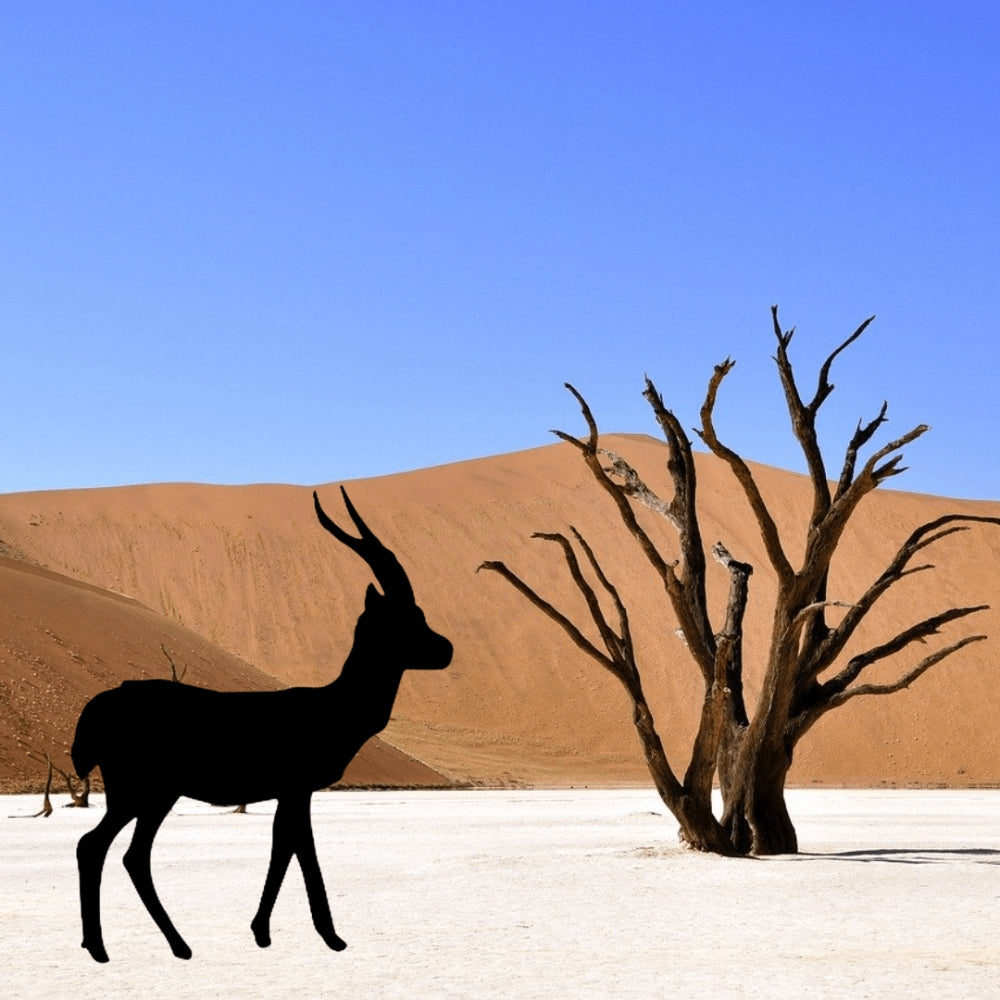 Precut glass shape of gazelle in a desert.