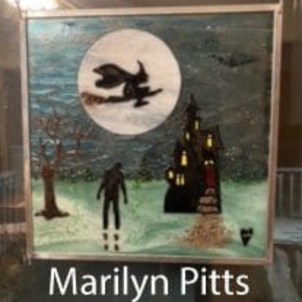 Precut glass shape of a haunted house in an art piece by Marilyn Pitts.