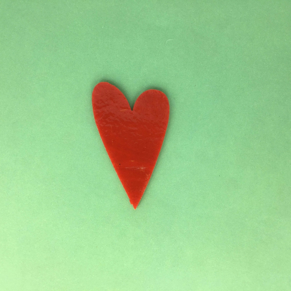 Precut glass shape of a heart in red.