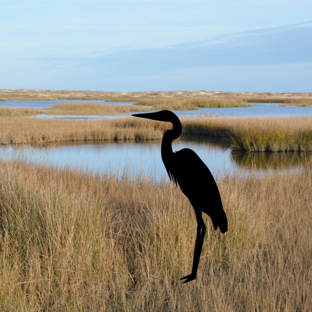 Precut glass shape of heron in marsh.