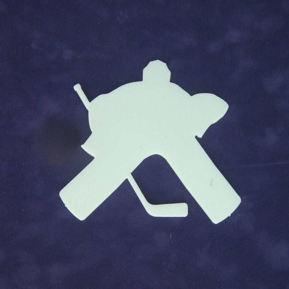 Precut glass shape of a hockey goalie in white.