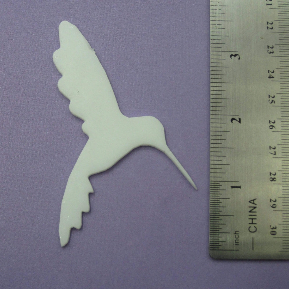 Precut glass shape of hummingbird.