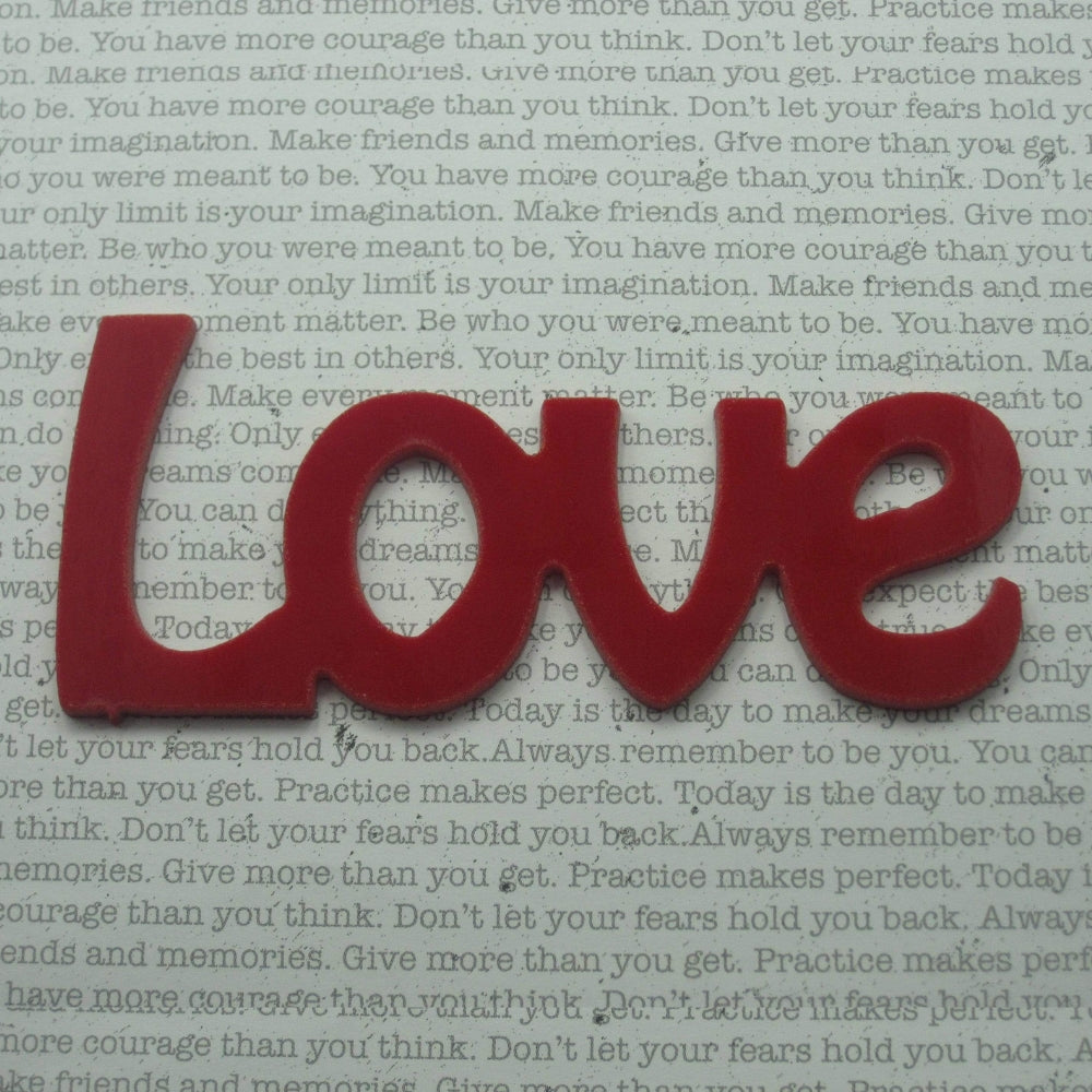 Precut glass shape of the word Love in red glass.