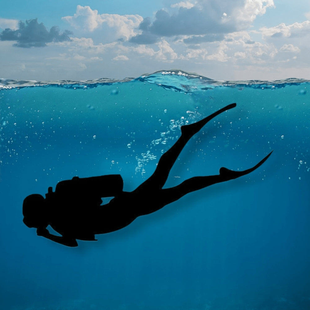 Precut glass shape of a scuba diver in the ocean.