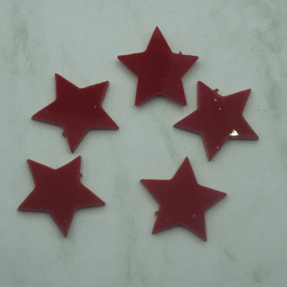 Precut glass shape of 5 stars cut from red glass.