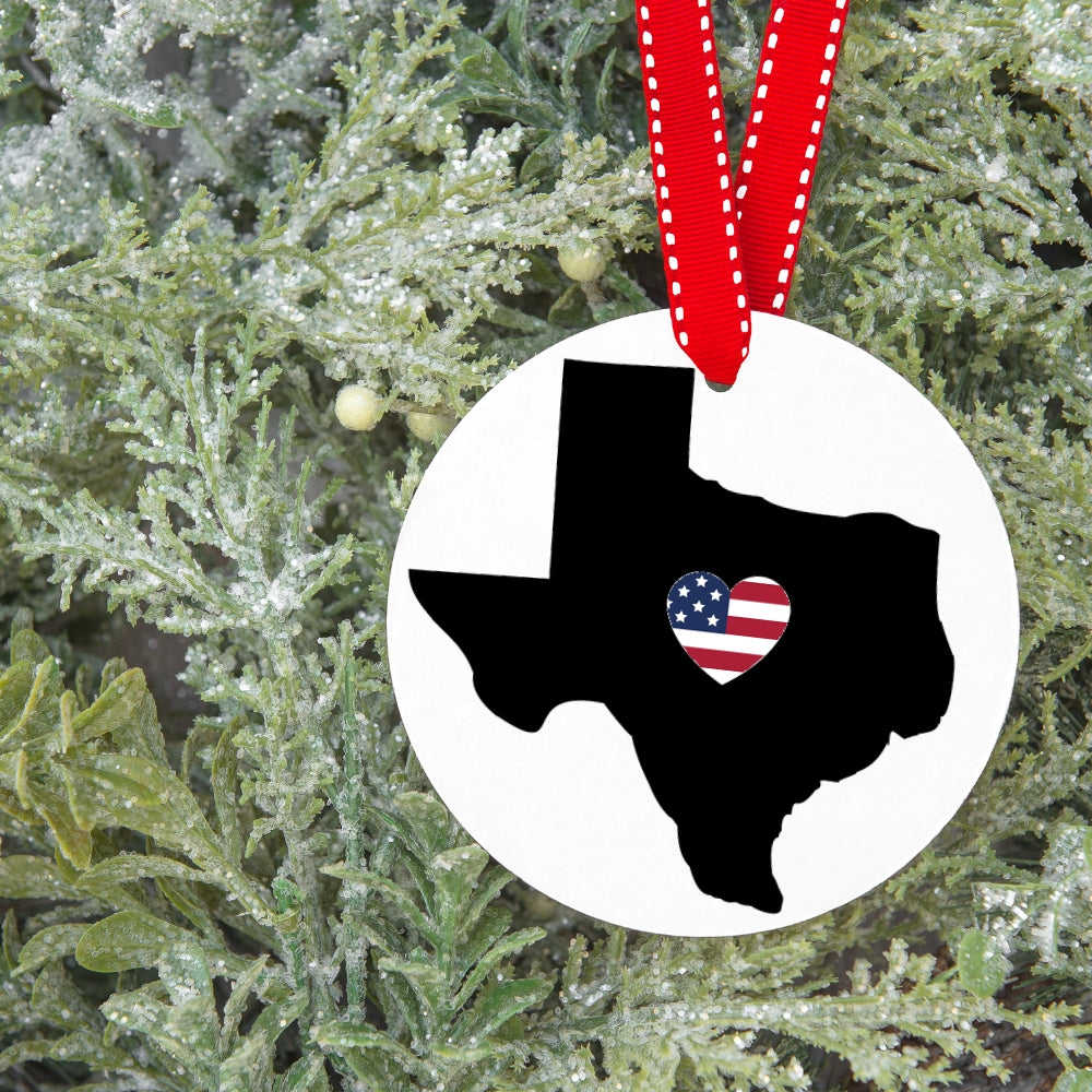 Precut glass shape of Texas with a us flag heart as an ornament.