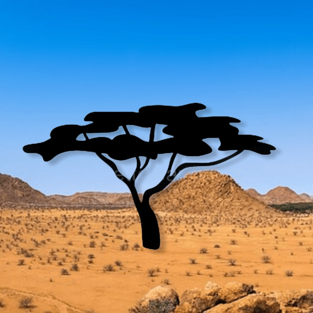 Precut glass shape of a tree in a desert.