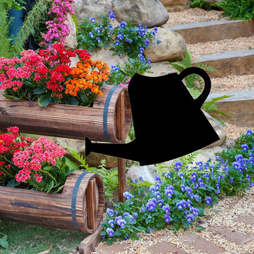 Precut glass shape of a watering can in flower garden.