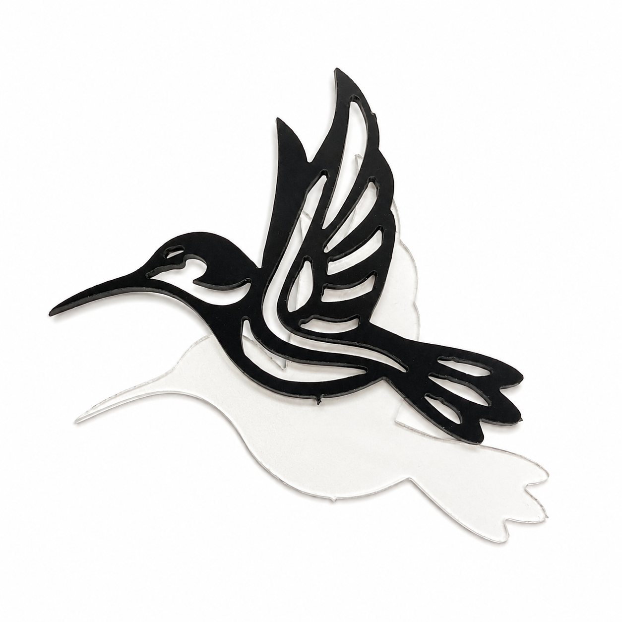 Black hummingbird outline layered over a clear precut glass hummingbird for a fused glass art project.