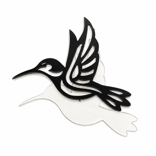 Black hummingbird outline layered over a clear precut glass hummingbird for a fused glass art project.