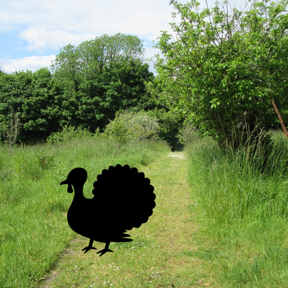 Precut Glass shape of a turkey cut from Bullseye COE 90 on a background of grass and bush