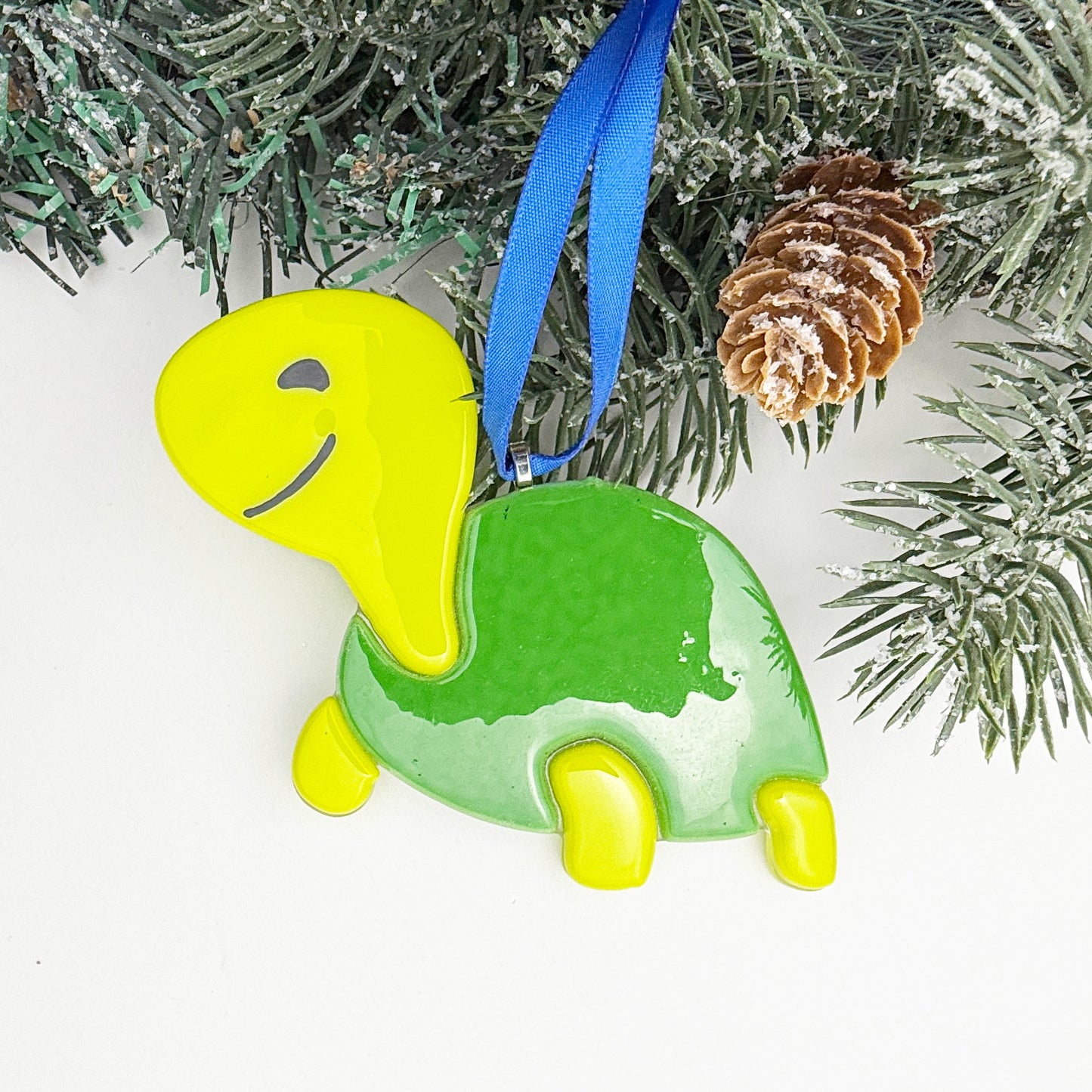 Cute fused glass turtle Christmas ornament in bright green and lemongrass colors, kid-friendly holiday décor.