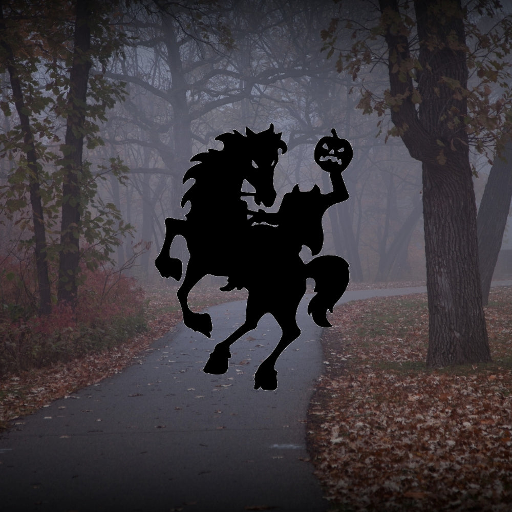 Headless horseman in black riding in a spooky forest